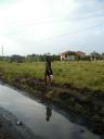 08-aug-2009-young-lady-walking-next-to-mud-hole.JPG